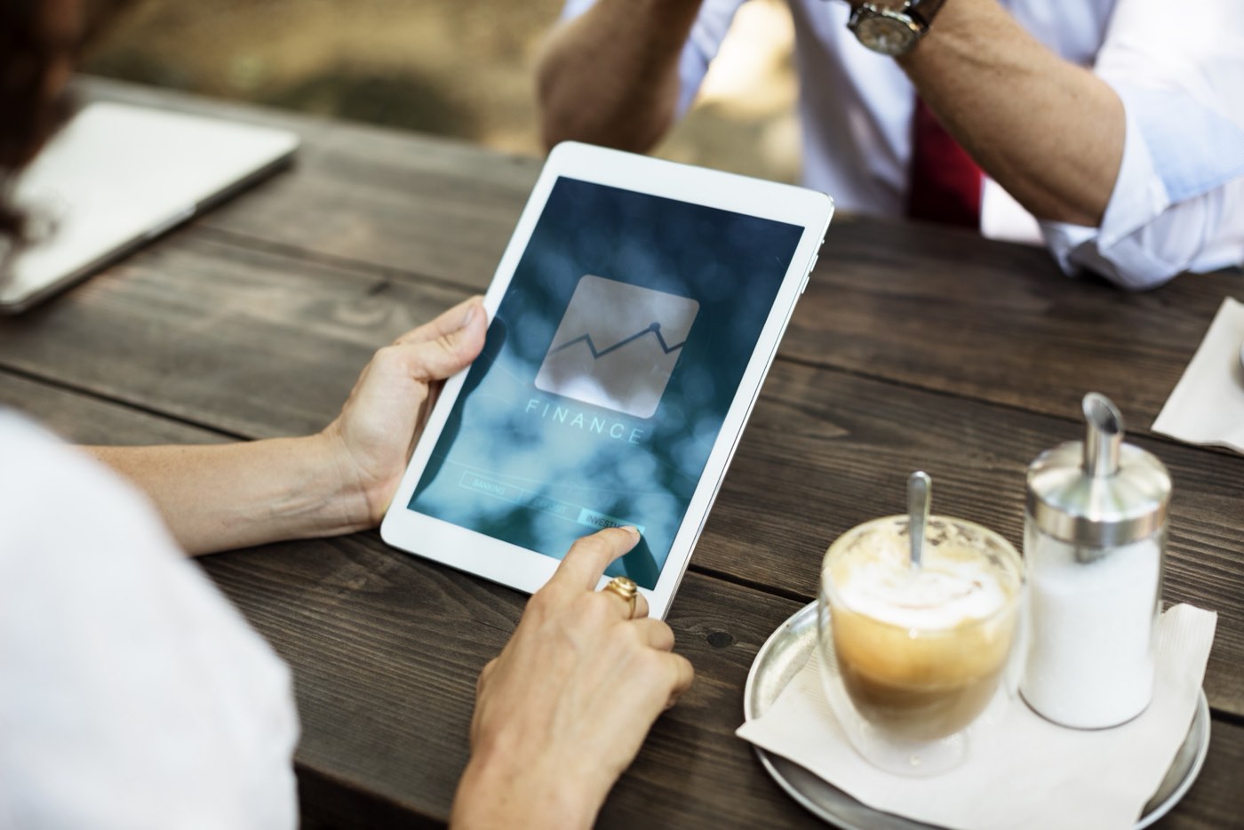 An analyst studies dashboards across several screens