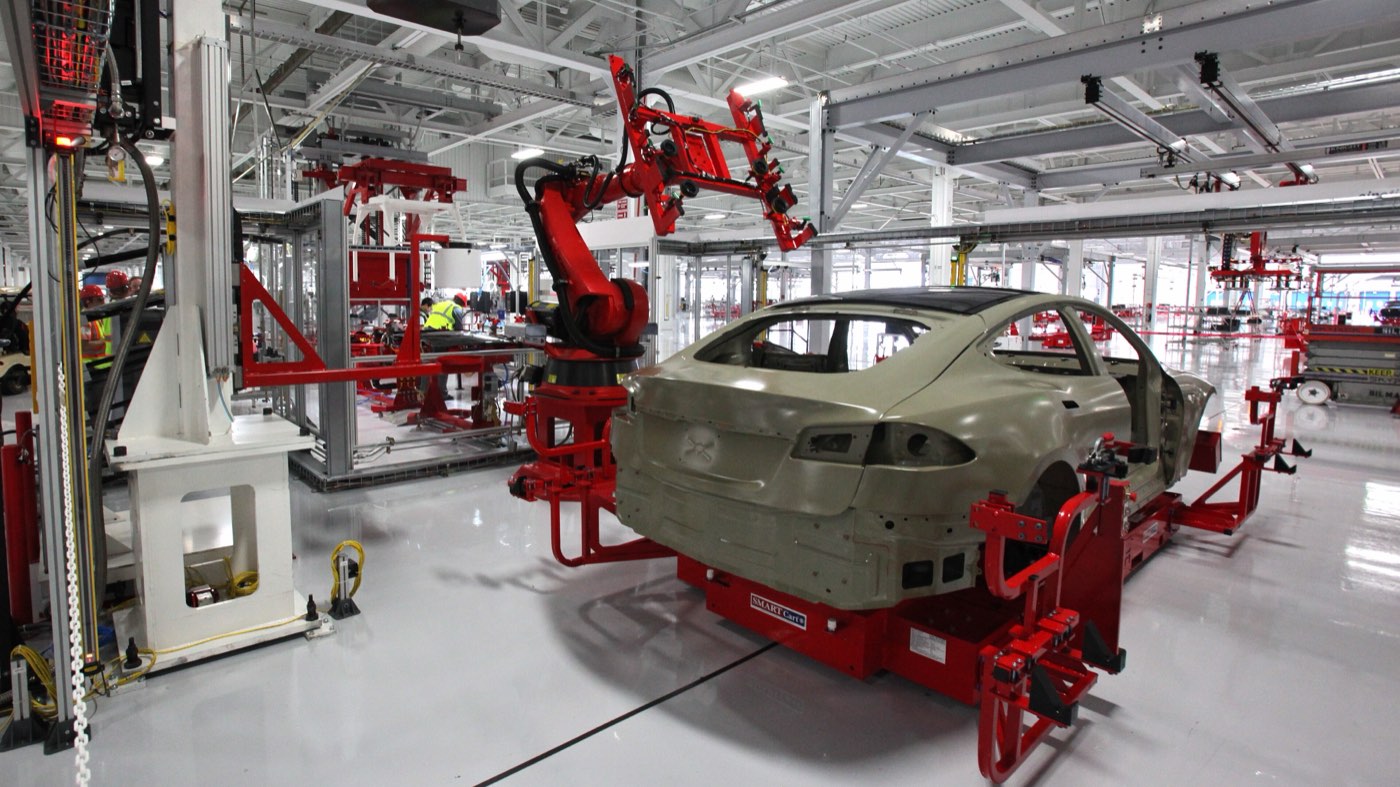 Robots welding car bodies on an assembly line
